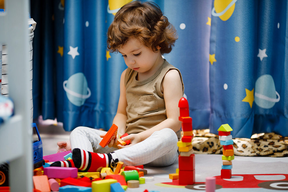 little-autistic-boy-playing-with-cubes-at-home